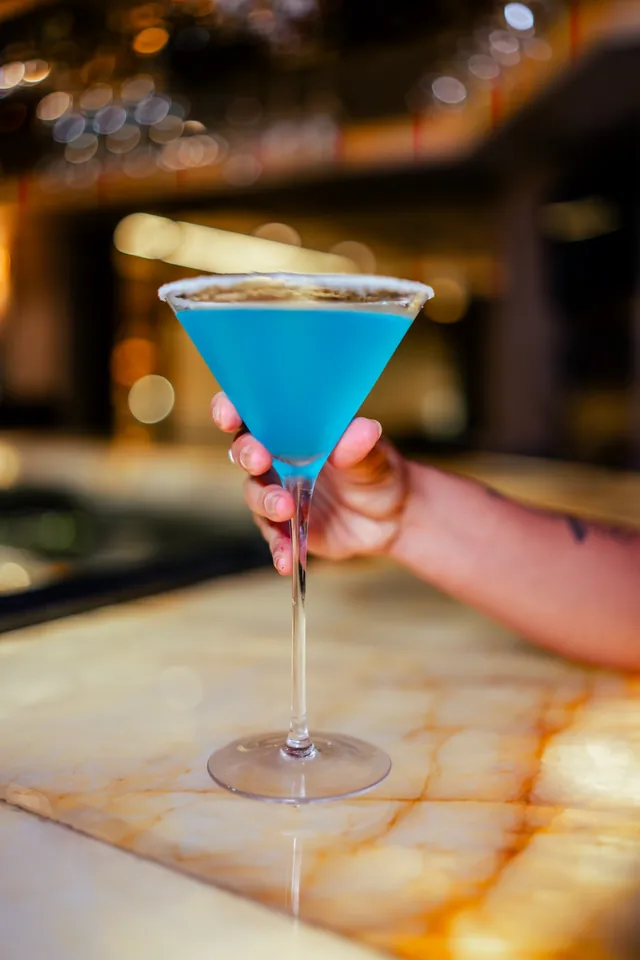 Bebida azul em taça martini
